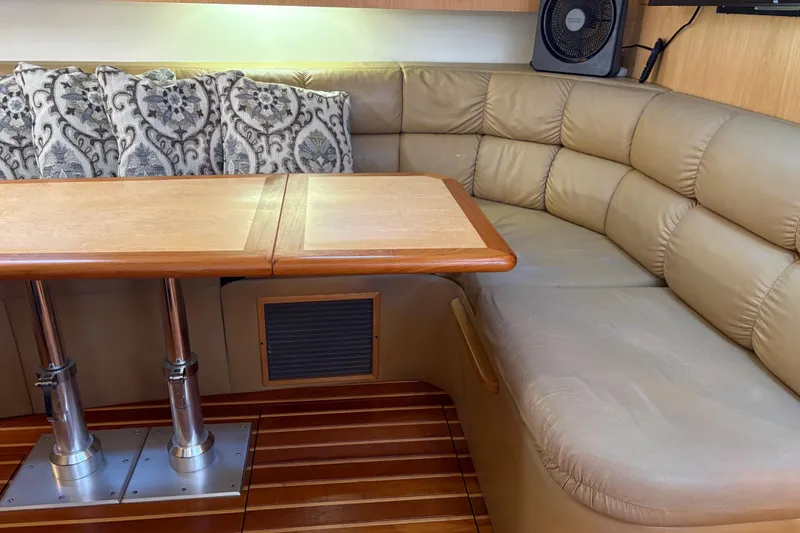 Slide: The Image of Luxurious interior of 1999 Tiara Yachts 4000 Express with leather seating and wooden table. - 31