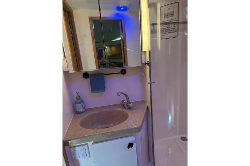 Slide: The Image of Bathroom interior of 1999 Tiara Yachts 4000 Express with sink and mirror. - 34