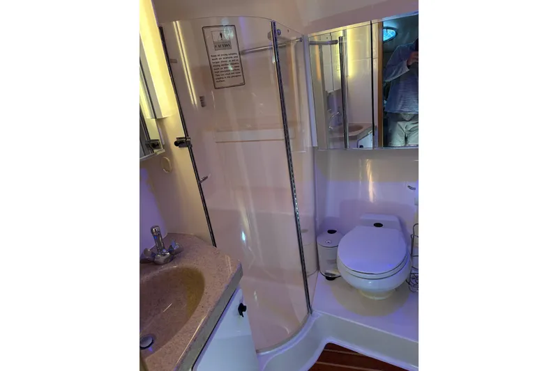 Slide: The Image of Bathroom interior of 1999 Tiara Yachts 4000 Express with shower, sink, and toilet. - 35