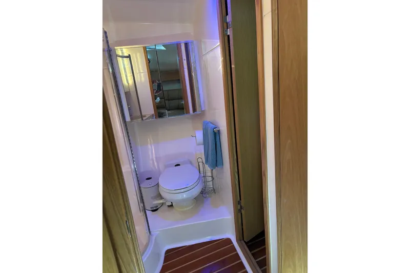Slide: The Image of Bathroom interior of 1999 Tiara Yachts 4000 Express with toilet and mirror. - 36