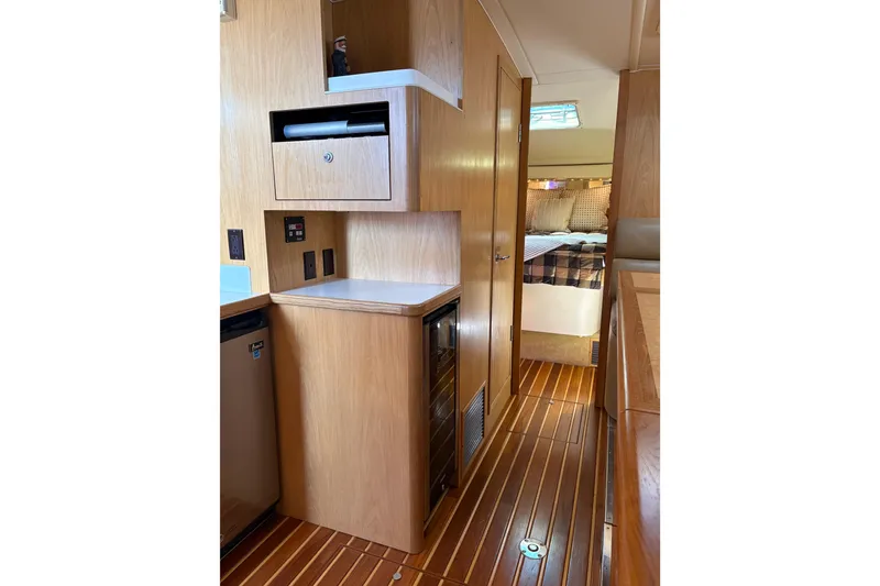Slide: The Image of Interior of 1999 Tiara Yachts 4000 Express, featuring wood cabinetry and cozy sleeping area. - 39