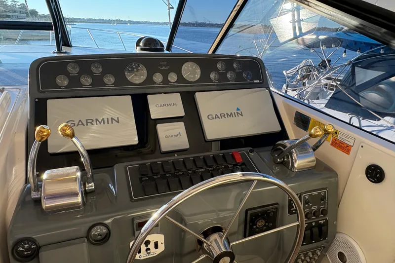 Slide: The Image of 1999 Tiara Yachts 4000 Express docked at marina during sunset. - 4