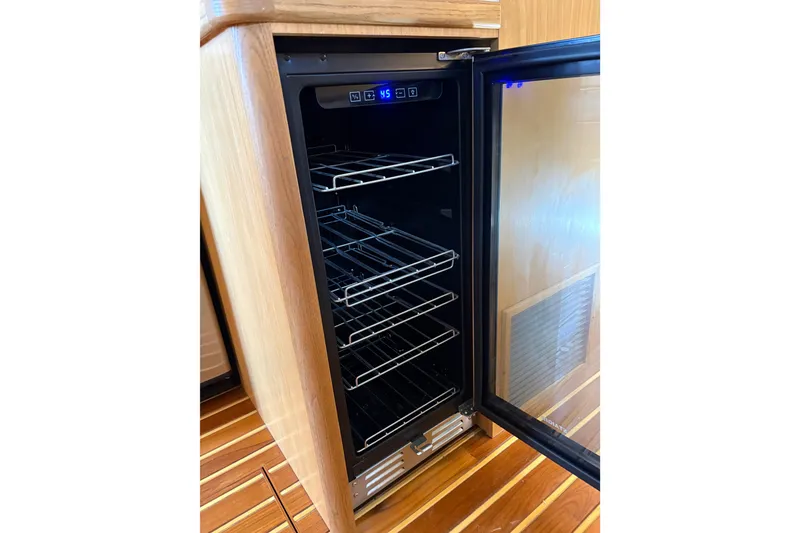 Slide: The Image of Open refrigerator in 1999 Tiara Yachts 4000 Express, showcasing interior shelving. - 44