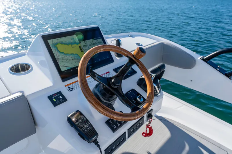 Slide: The Image of Everglades 455 Center Console 2026 helm with navigation display on open water. - 36