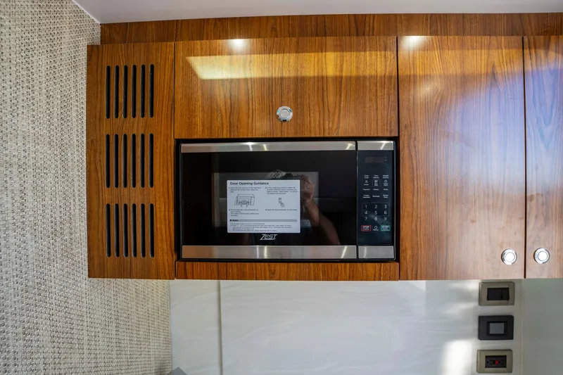 Slide: The Image of Microwave in wooden cabinet on Everglades 455 Center Console 2026. - 46