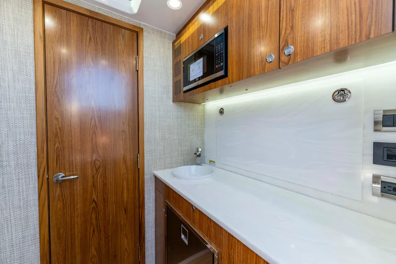 Slide: The Image of Interior of Everglades 455 Center Console 2026 with wood paneling. - 51