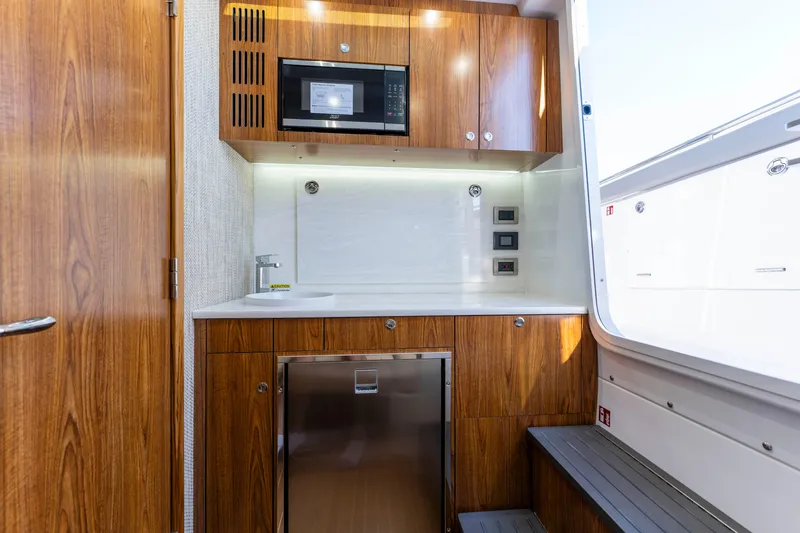 Slide: The Image of Interior of Everglades 455 Center Console 2026 with wooden cabinetry. - 54