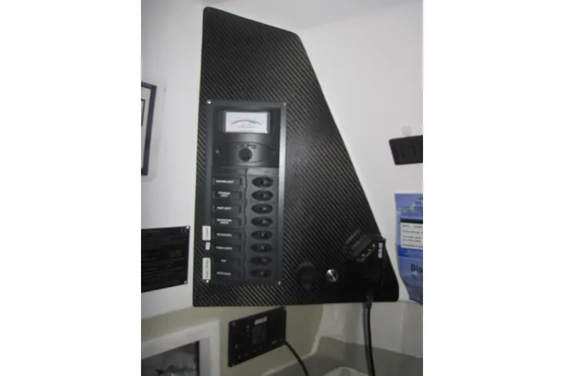 Slide: The Image of Control panel inside 2022 Corsair 880 Standard boat, featuring switches and a gauge. - 11