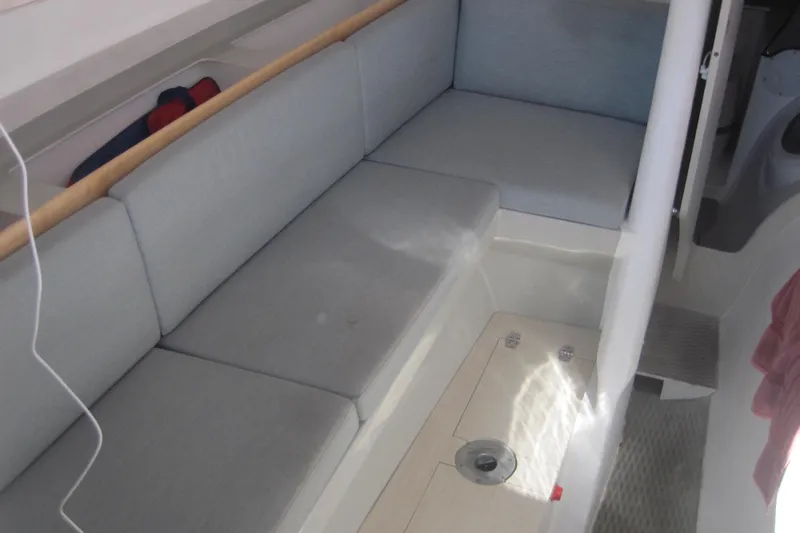 Slide: The Image of Interior of 2022 Corsair 880 Standard sailboat with cushioned seating area. - 17