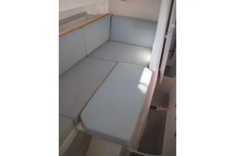 Slide: The Image of Interior seating of 2022 Corsair 880 Standard sailboat, featuring light blue cushions. - 19