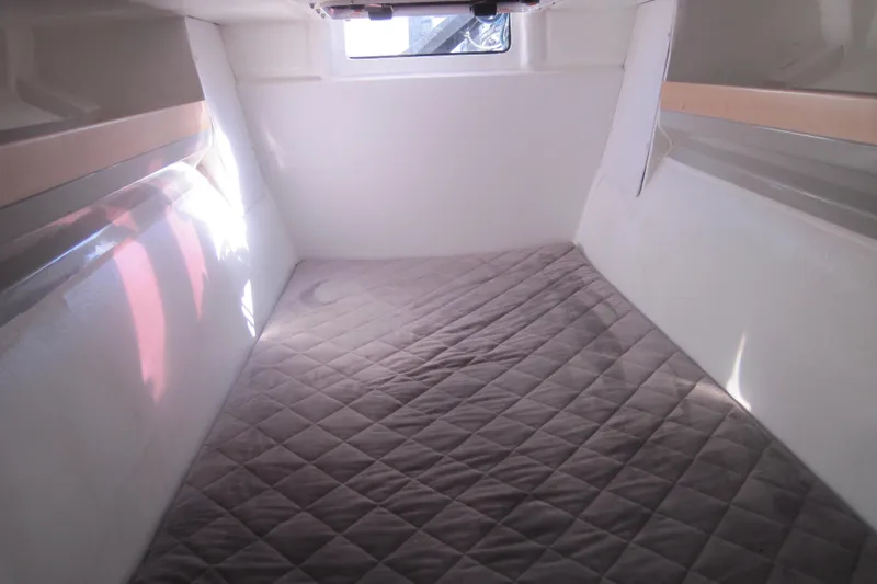Slide: The Image of Interior cabin of 2022 Corsair 880 Standard sailboat with quilted bedding. - 21