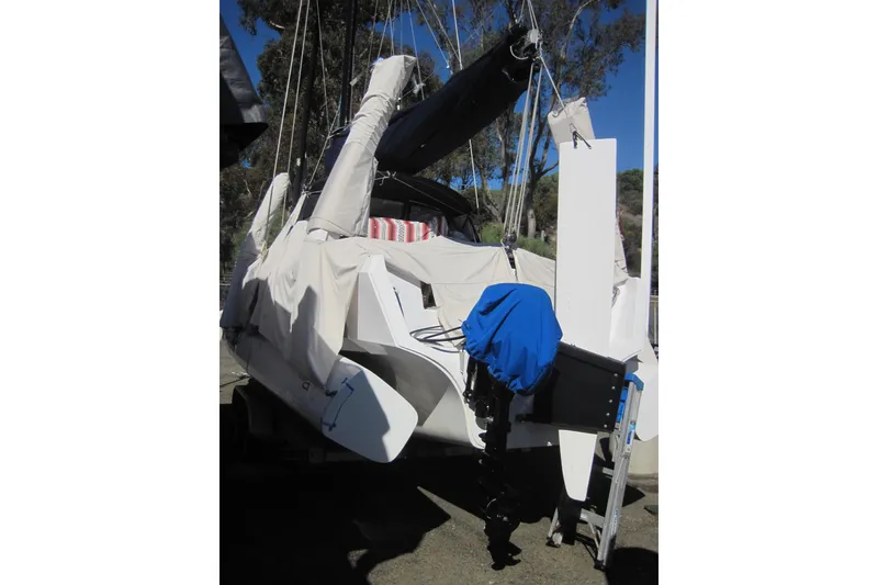 Slide: The Image of 2022 Corsair 880 Standard sailboat with protective covers, docked outdoors. - 25