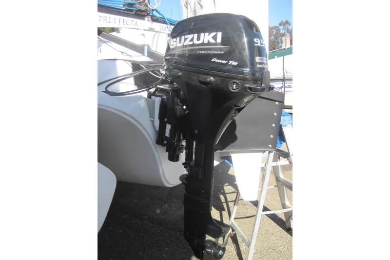 Slide: The Image of Suzuki outboard motor on 2022 Corsair 880 Standard boat, docked outdoors. - 27