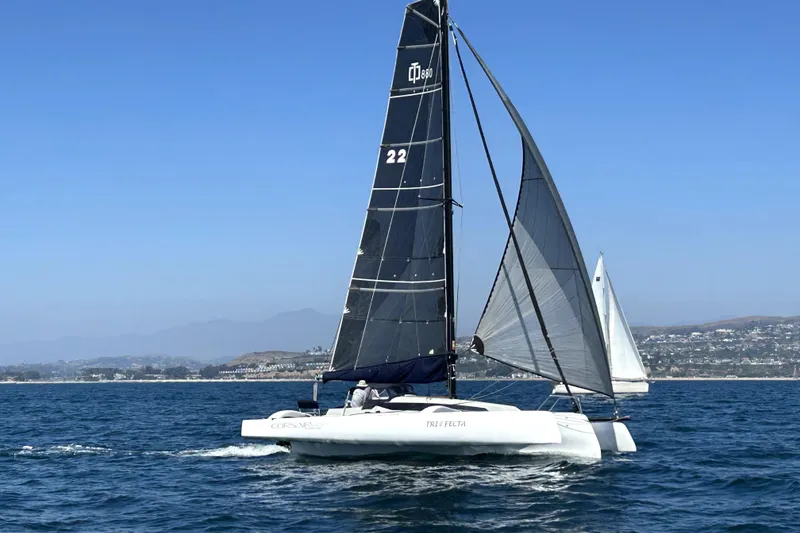 Slide: The Image of Sailing Corsair 880 Standard 2022 on open water, clear sky, coastal background. - 3