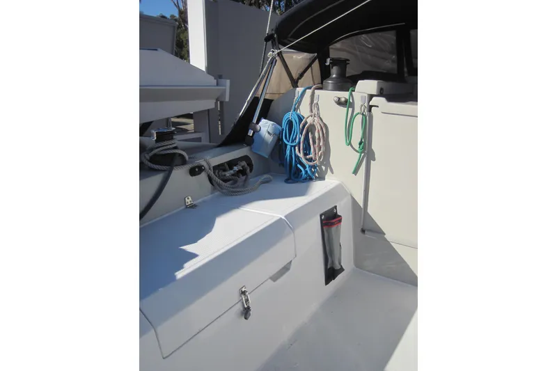 Slide: The Image of 2022 Corsair 880 Standard sailboat cockpit with ropes and storage compartments. - 5