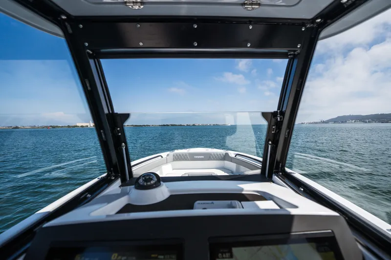 Slide: The Image of 2025 Everglades 285 Center Console boat navigating open waters under clear skies. - 11