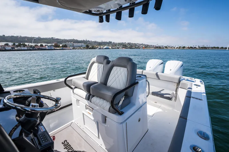 Slide: The Image of 2025 Everglades 285 Center Console boat interior with dual seats and ocean view. - 16