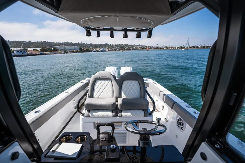 Slide: The Image of 2025 Everglades 285 Center Console boat interior with luxurious seating and scenic water view. - 18