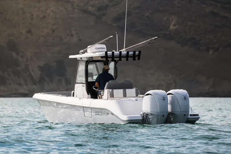 Slide: The Image of 2025 Everglades 285 Center Console boat on water, featuring dual engines. - 2