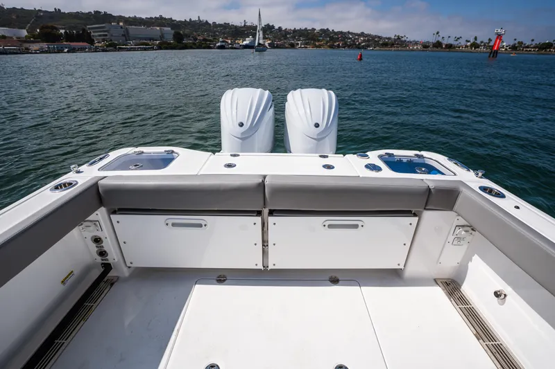 Slide: The Image of 2025 Everglades 285 Center Console boat with dual engines on calm water. - 23