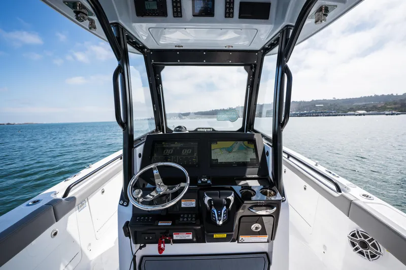 Slide: The Image of 2025 Everglades 285 Center Console boat helm with navigation system on open water. - 7