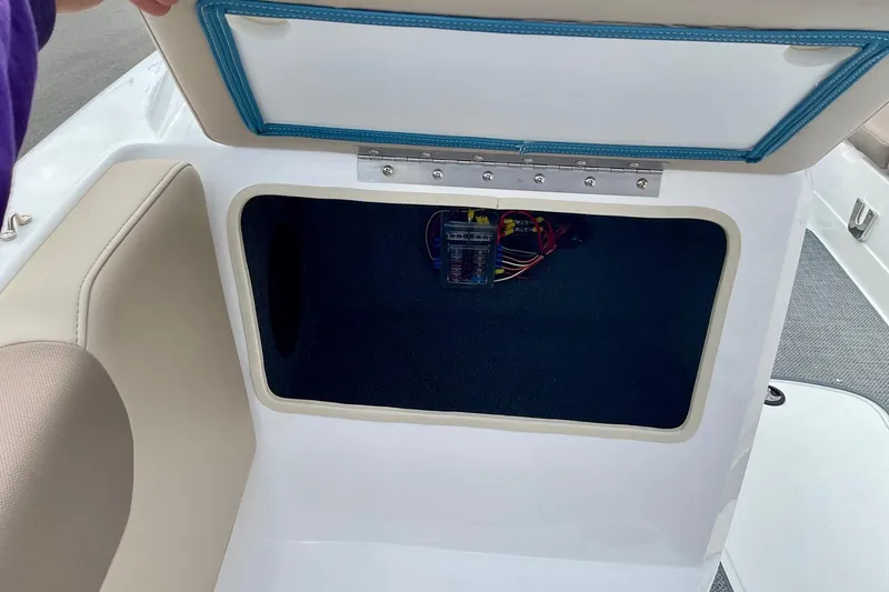 Slide: The Image of Open storage compartment in 2026 Tahoe 2150 boat, showing wiring and interior details. - 10