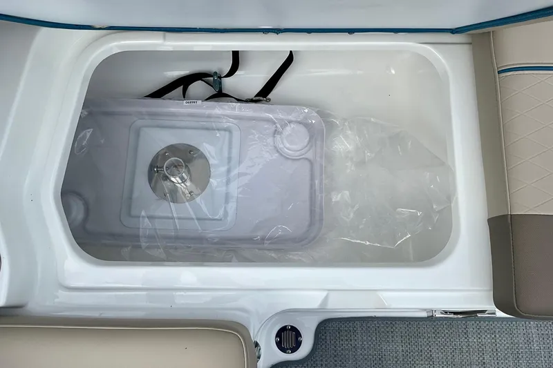 Slide: The Image of Storage compartment in 2026 Tahoe 2150 boat, featuring a secure latch and spacious interior. - 13