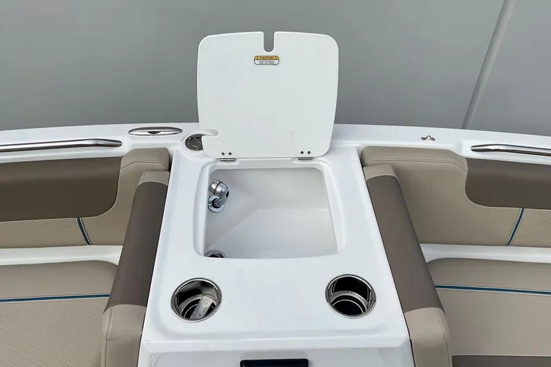 Slide: The Image of 2026 Tahoe 2150 boat interior with open storage compartment and cup holders. - 17