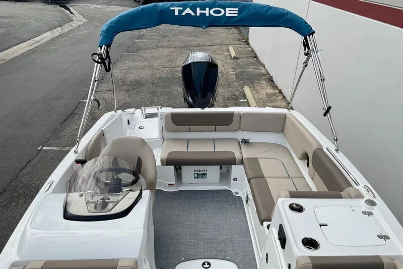 Slide: The Image of 2026 Tahoe 2150 boat interior with seating, steering wheel, and canopy. - 19