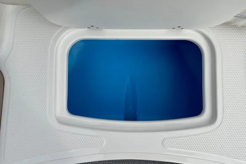 Slide: The Image of 2026 Tahoe 2150 boat storage compartment with blue interior. - 23