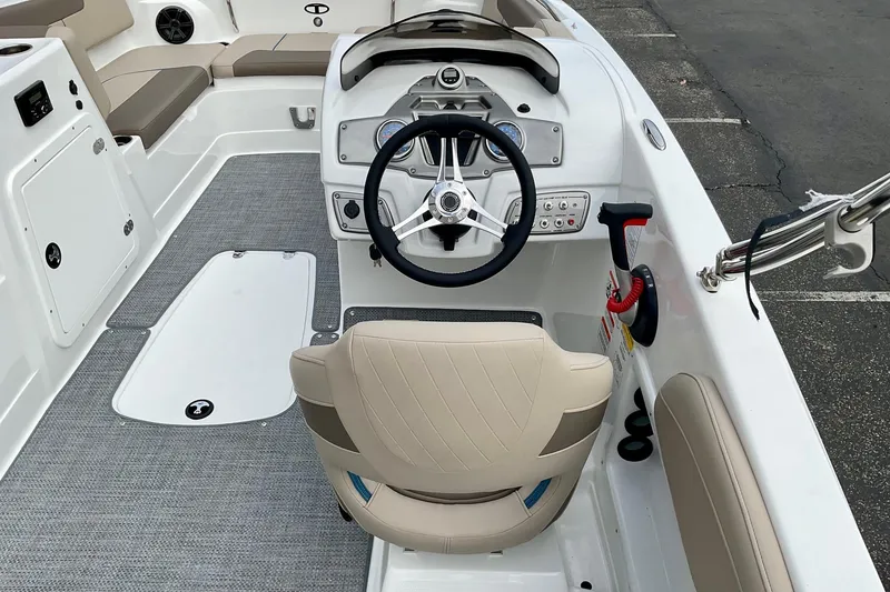 Slide: The Image of 2026 Tahoe 2150 boat interior with steering wheel and seating, showcasing modern design. - 26