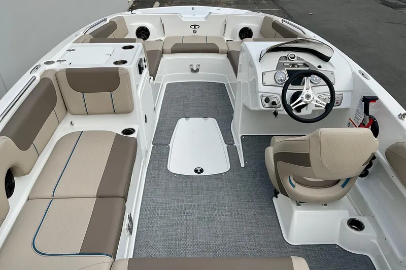 Slide: The Image of 2026 Tahoe 2150 boat interior with beige seating and modern steering console. - 27