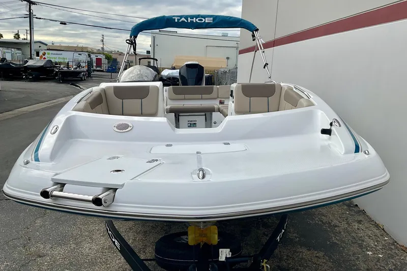 Slide: The Image of 2026 Tahoe 2150 boat with seating, docked outdoors, showcasing sleek design and spacious interior. - 7