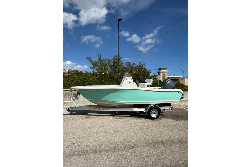 Slide: The Image of 2020 Tidewater 198 CC Adventure boat on trailer under blue sky. - 5
