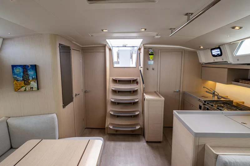 Slide: The Image of Interior of 2020 Beneteau Oceanis 46.1 yacht, featuring modern kitchen and seating area. - 20