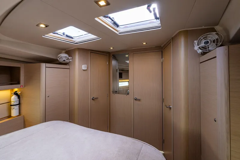 Slide: The Image of Interior of 2020 Beneteau Oceanis 46.1 yacht cabin with modern wood finish. - 25