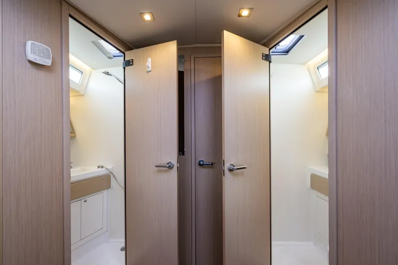 Slide: The Image of Interior of 2020 Beneteau Oceanis 46.1 yacht, featuring dual bathroom doors. - 26