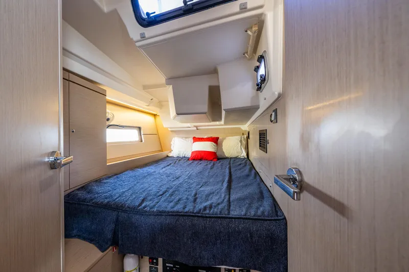 Slide: The Image of Cozy cabin interior of 2020 Beneteau Oceanis 46.1 yacht with bed and window. - 31