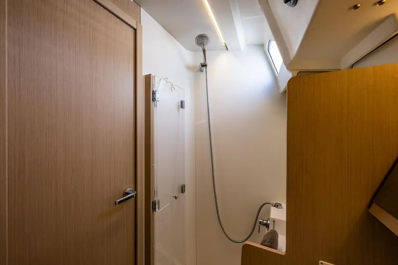 Slide: The Image of Bathroom interior of 2020 Beneteau Oceanis 46.1 yacht, featuring modern shower and wooden finishes. - 39