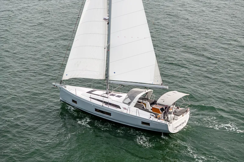 Slide: The Image of 2020 Beneteau Oceanis 46.1 sailing yacht on open water, showcasing sleek design and white sails. - 60