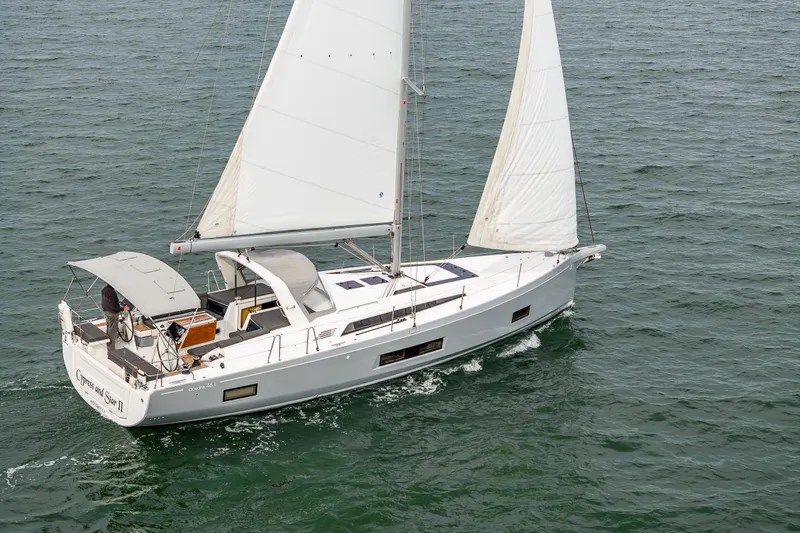 Slide: The Image of 2020 Beneteau Oceanis 46.1 sailing on open water, showcasing sleek design and white sails. - 62