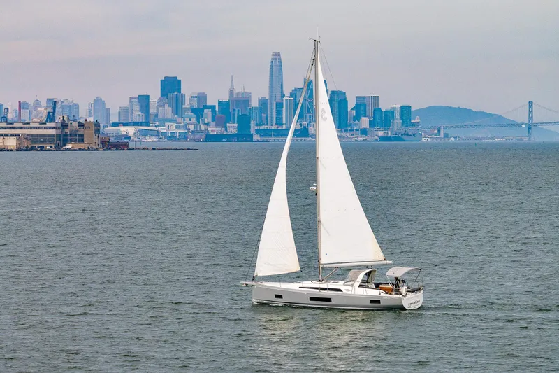 Slide: The Image of Sailing yacht Beneteau Oceanis 46.1, 2020 model, with city skyline backdrop. - 66