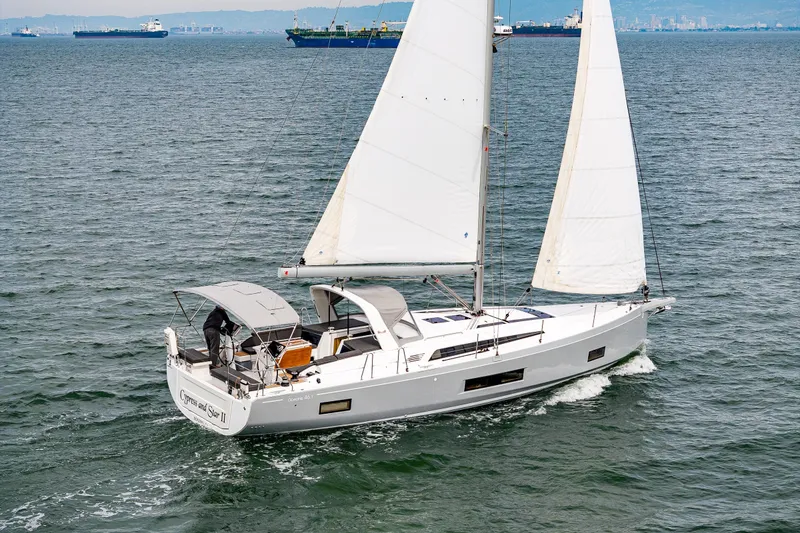 Slide: The Image of 2020 Beneteau Oceanis 46.1 sailing on open water, showcasing sleek design and white sails. - 67