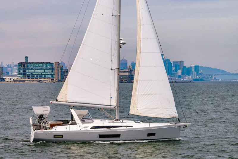 Slide: The Image of 2020 Beneteau Oceanis 46.1 sailing near city skyline, showcasing sleek design and spacious deck. - 69