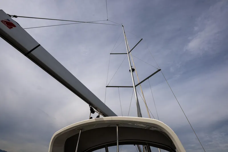 Slide: The Image of 2020 Beneteau Oceanis 46.1 sailboat mast against a cloudy sky. - 81