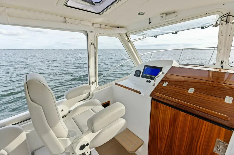 Slide: The Image of Interior of 2025 MJM 35 boat with helm, luxurious seating, and ocean view. - 18