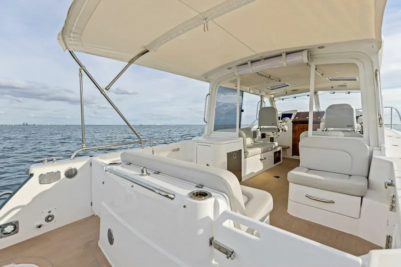 Slide: The Image of 2025 MJM 35 boat interior with seating, canopy, and ocean view. - 22