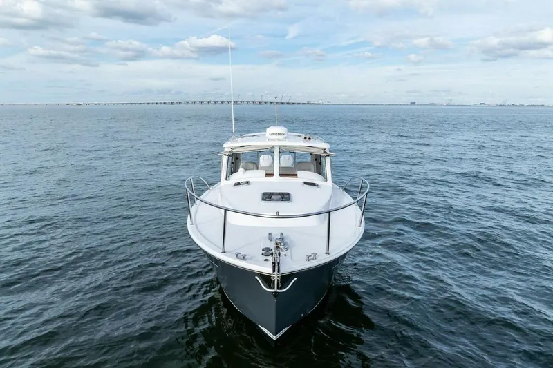 Slide: The Image of 2025 MJM 35 boat on open water under a cloudy sky. - 46