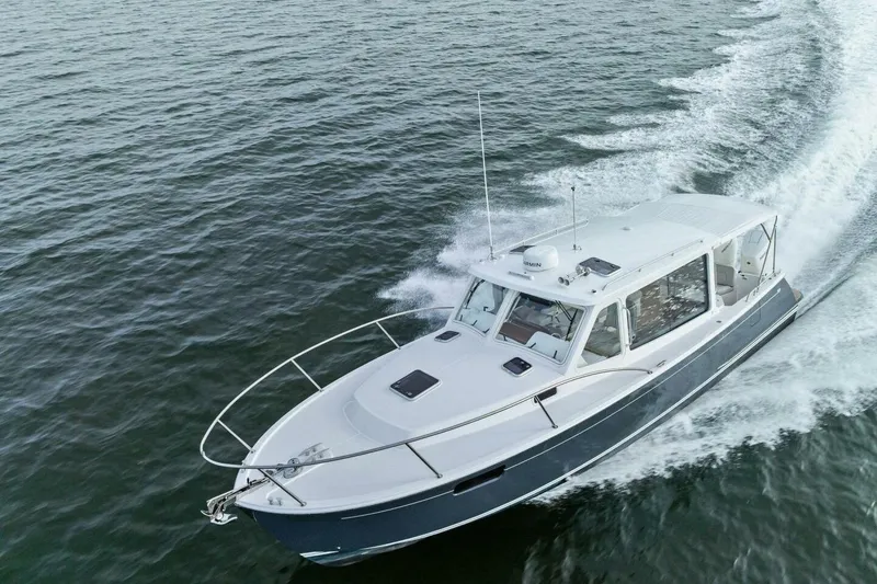 Slide: The Image of 2025 MJM 35 boat cruising on open water, showcasing sleek design and performance. - 52
