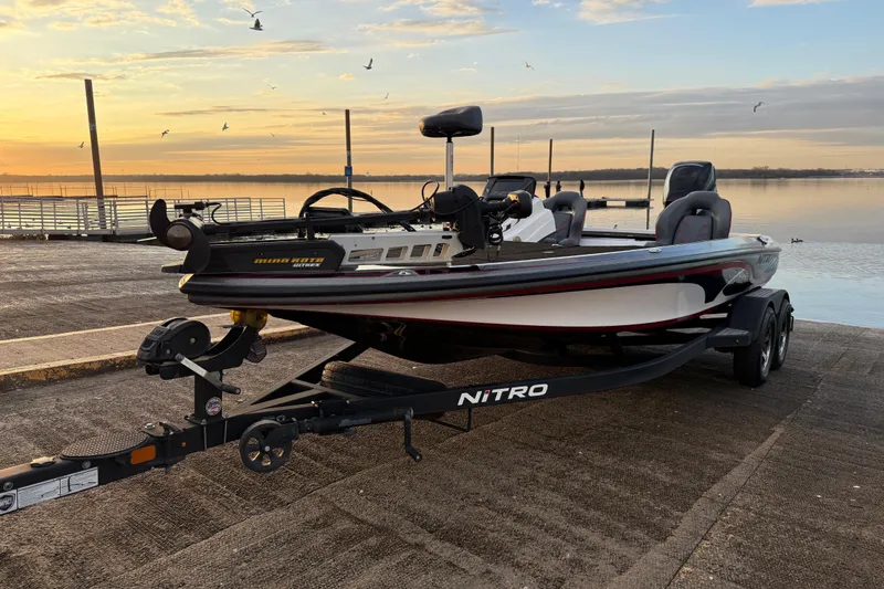 The Image of 2020 Nitro Z20 boat on trailer at sunrise by a lake. - 0